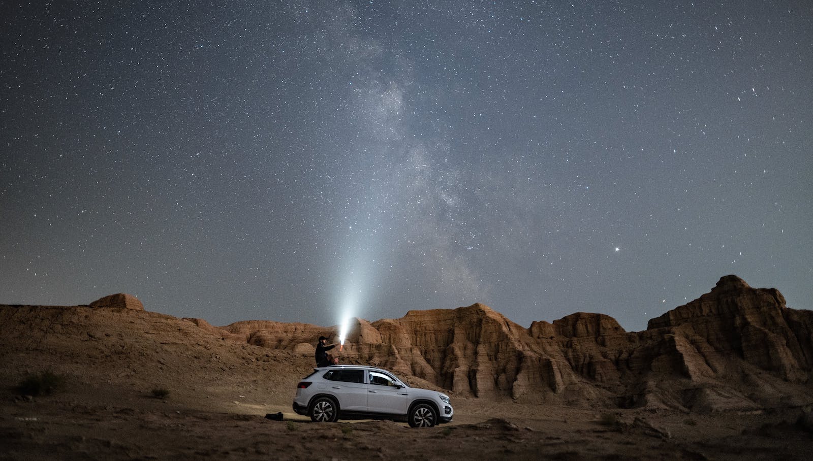 White SUV underneath starry sky
