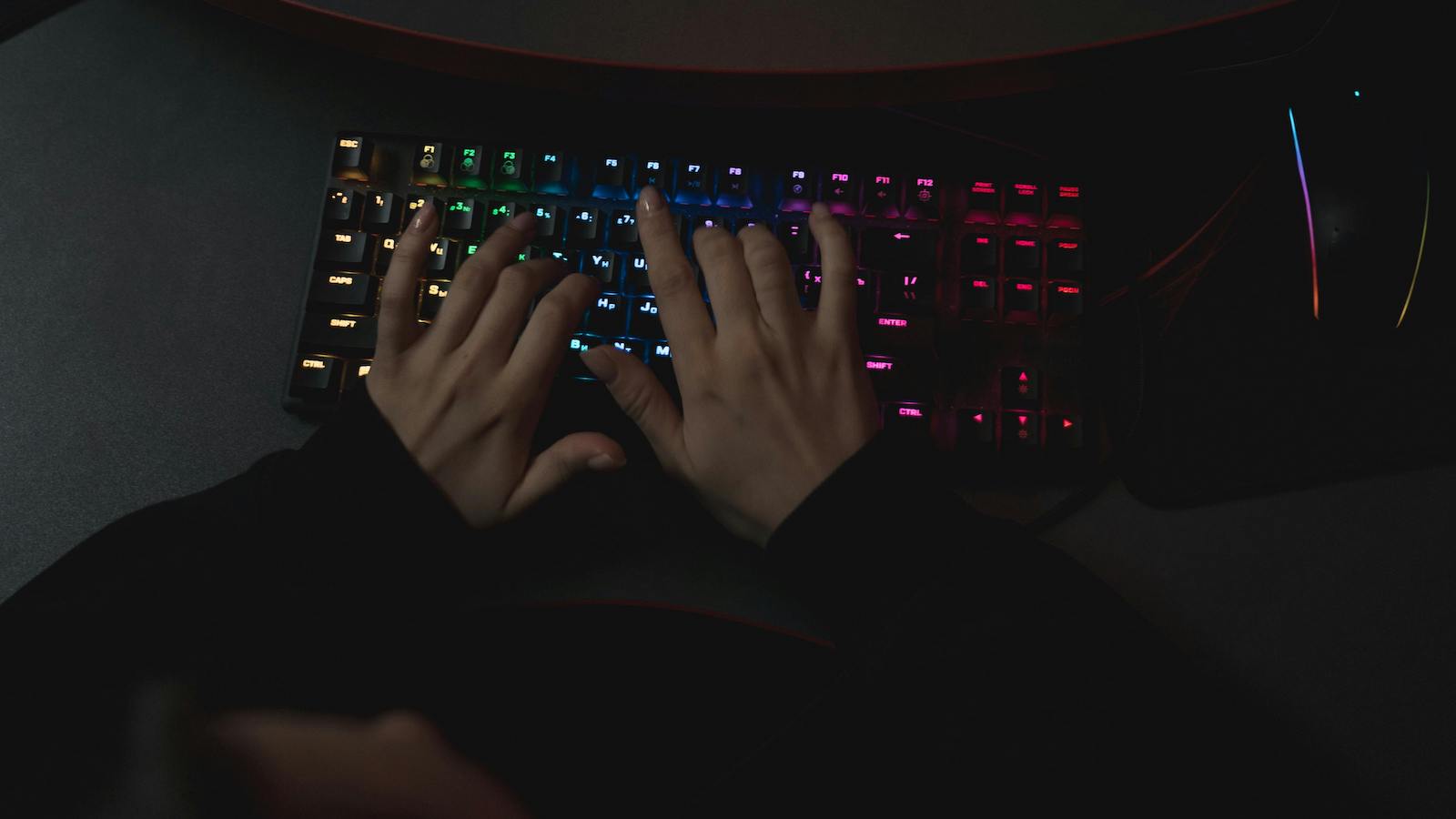 Person using a rainbow colored keyboard