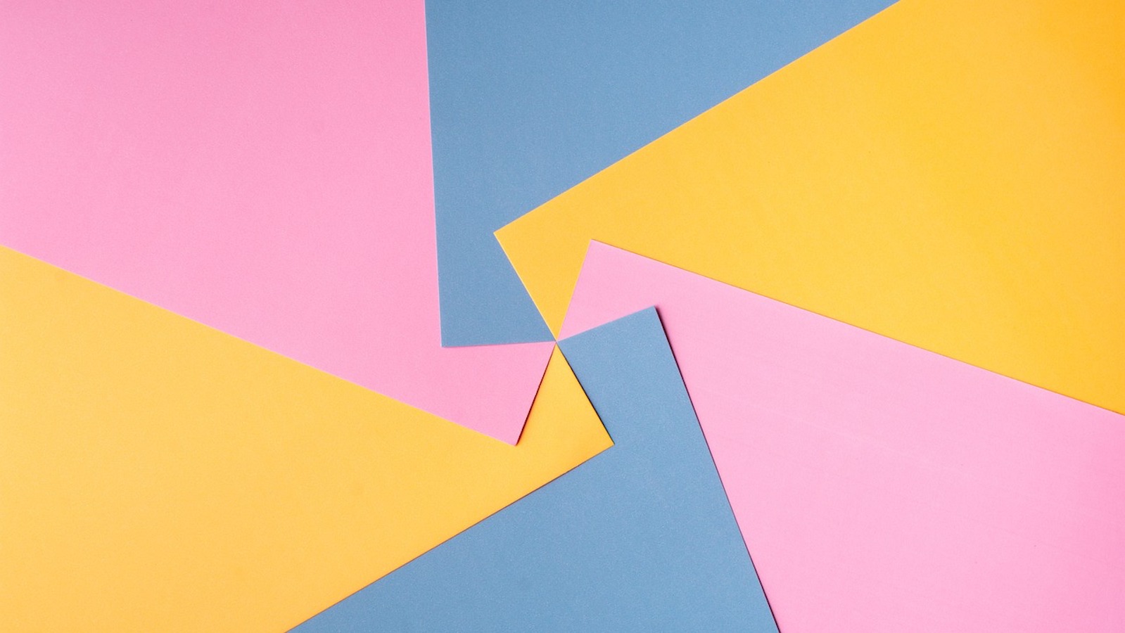 Blue, yellow, and pink pieces of paper swirled