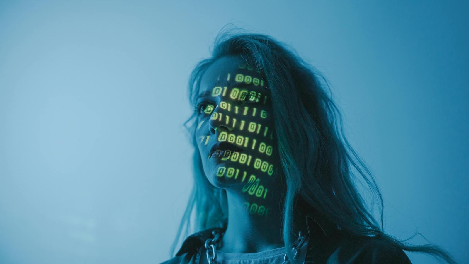 A woman looking afar with binary projected on her face