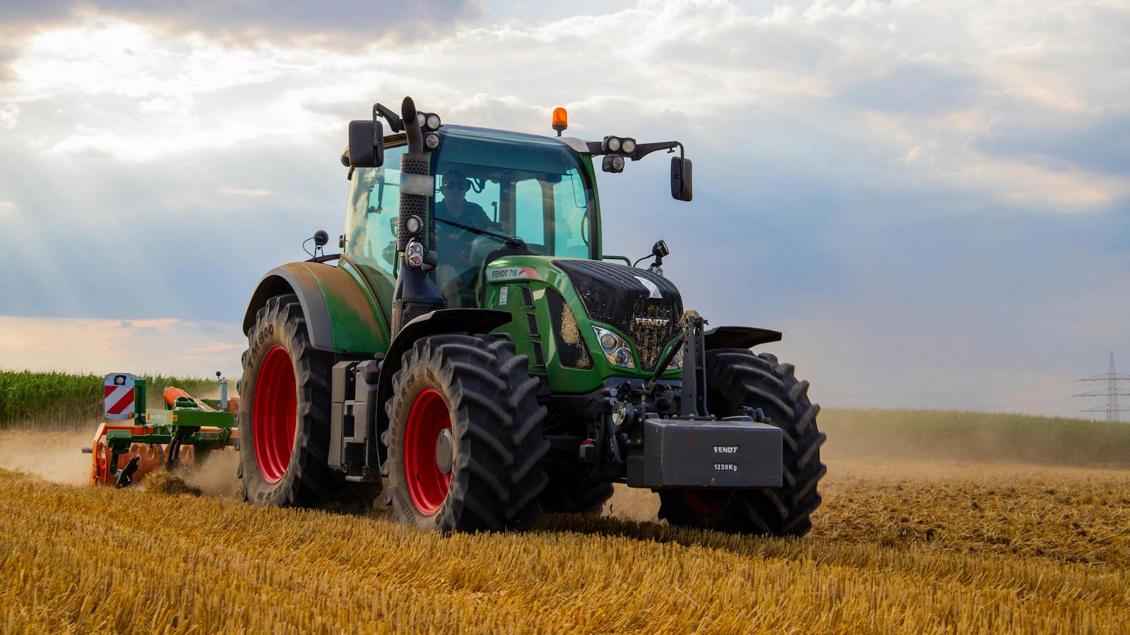 Green Tractor Plowing The Fields on Focus Photography