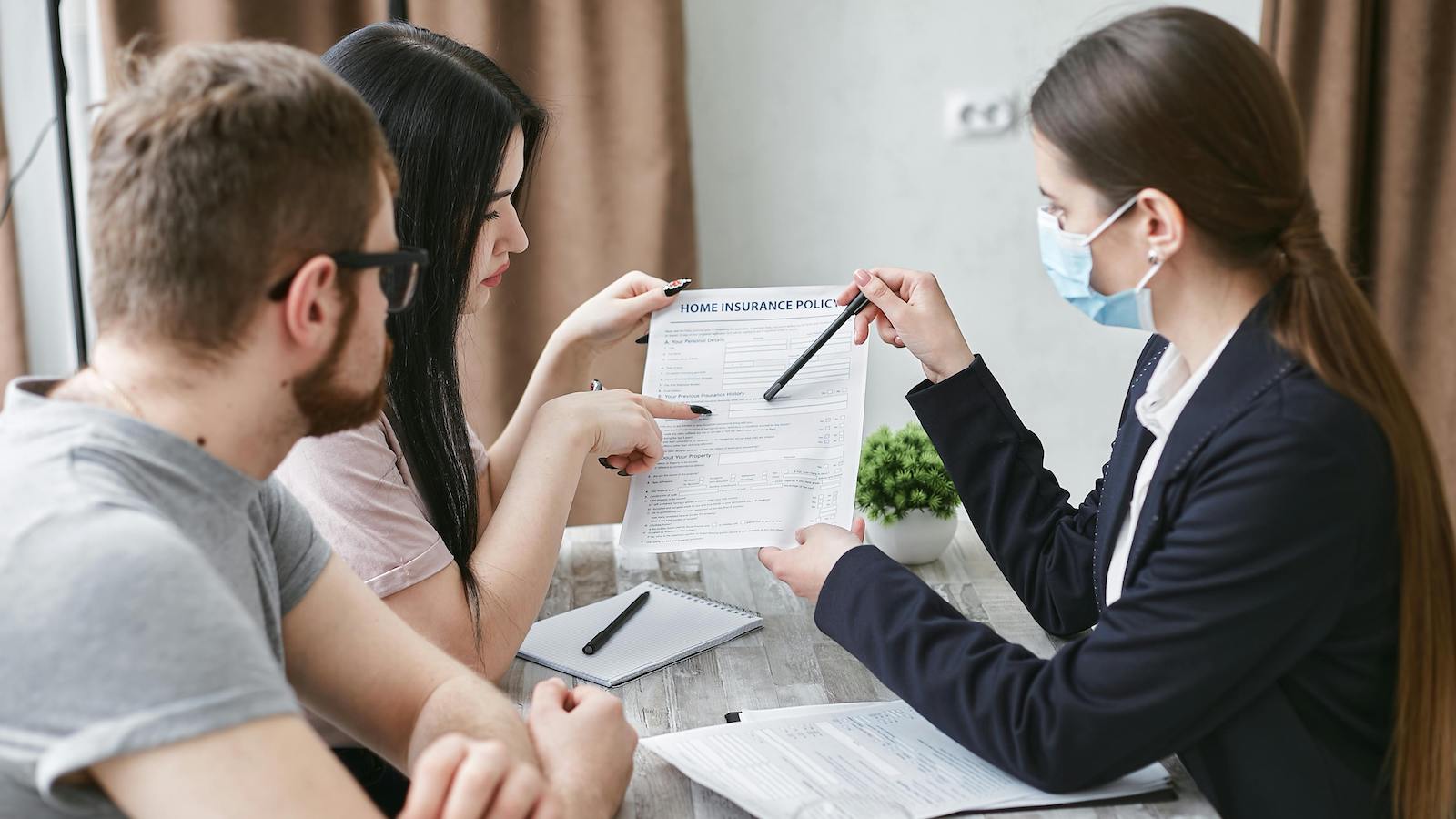 A Woman Explaining a Document to a Couple