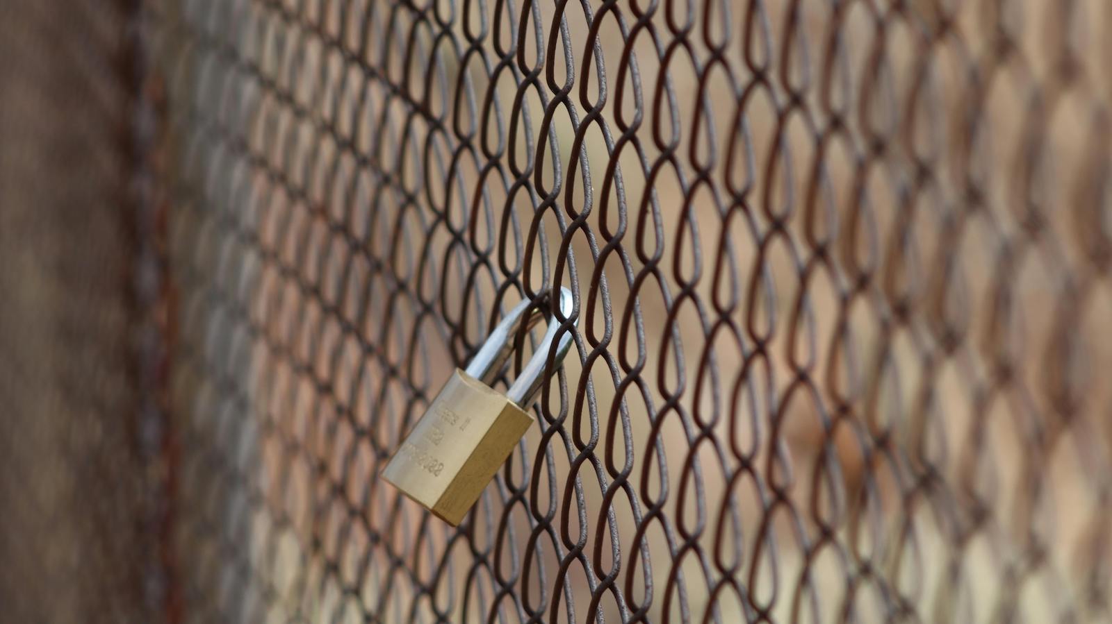 A Padlock on a Fence