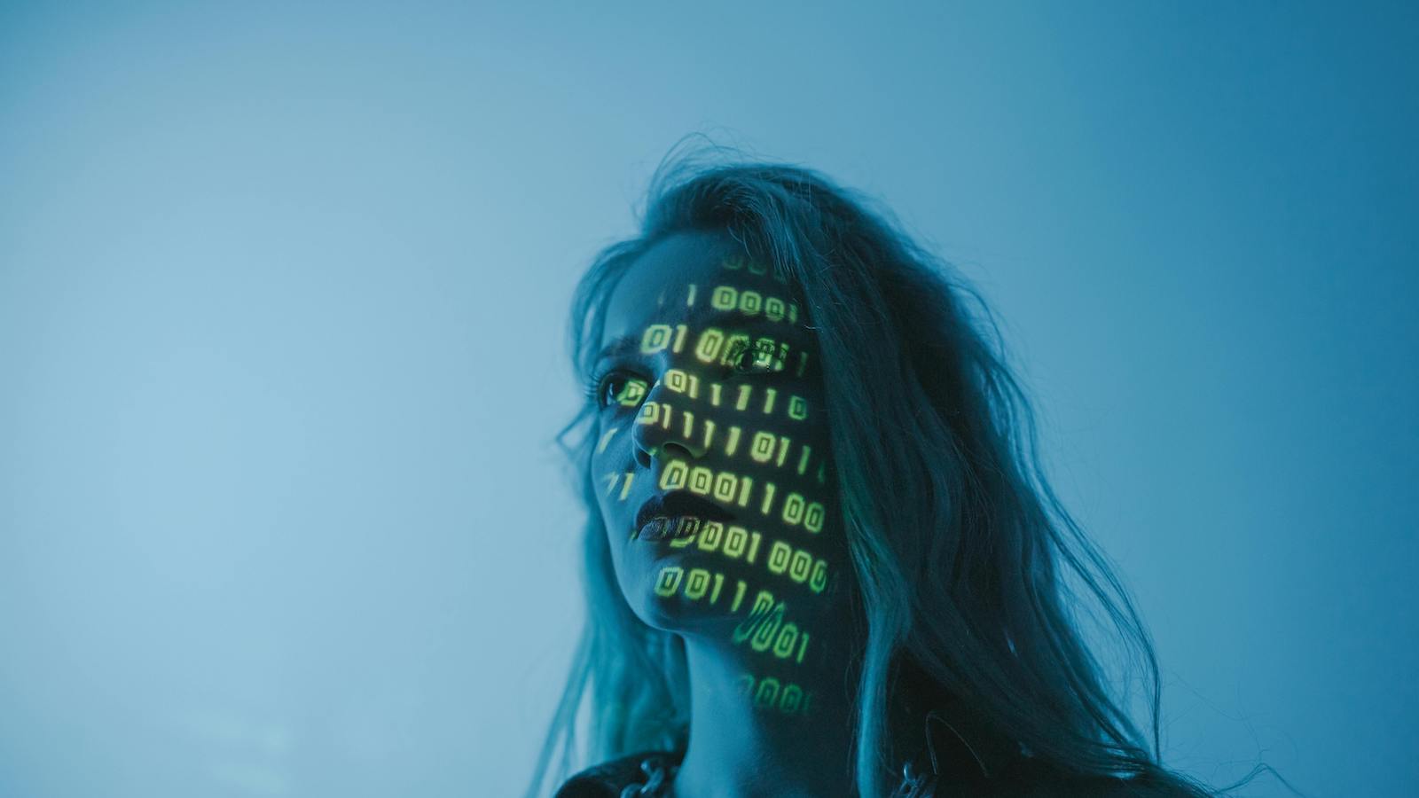 A woman looking afar with binary projected on her face