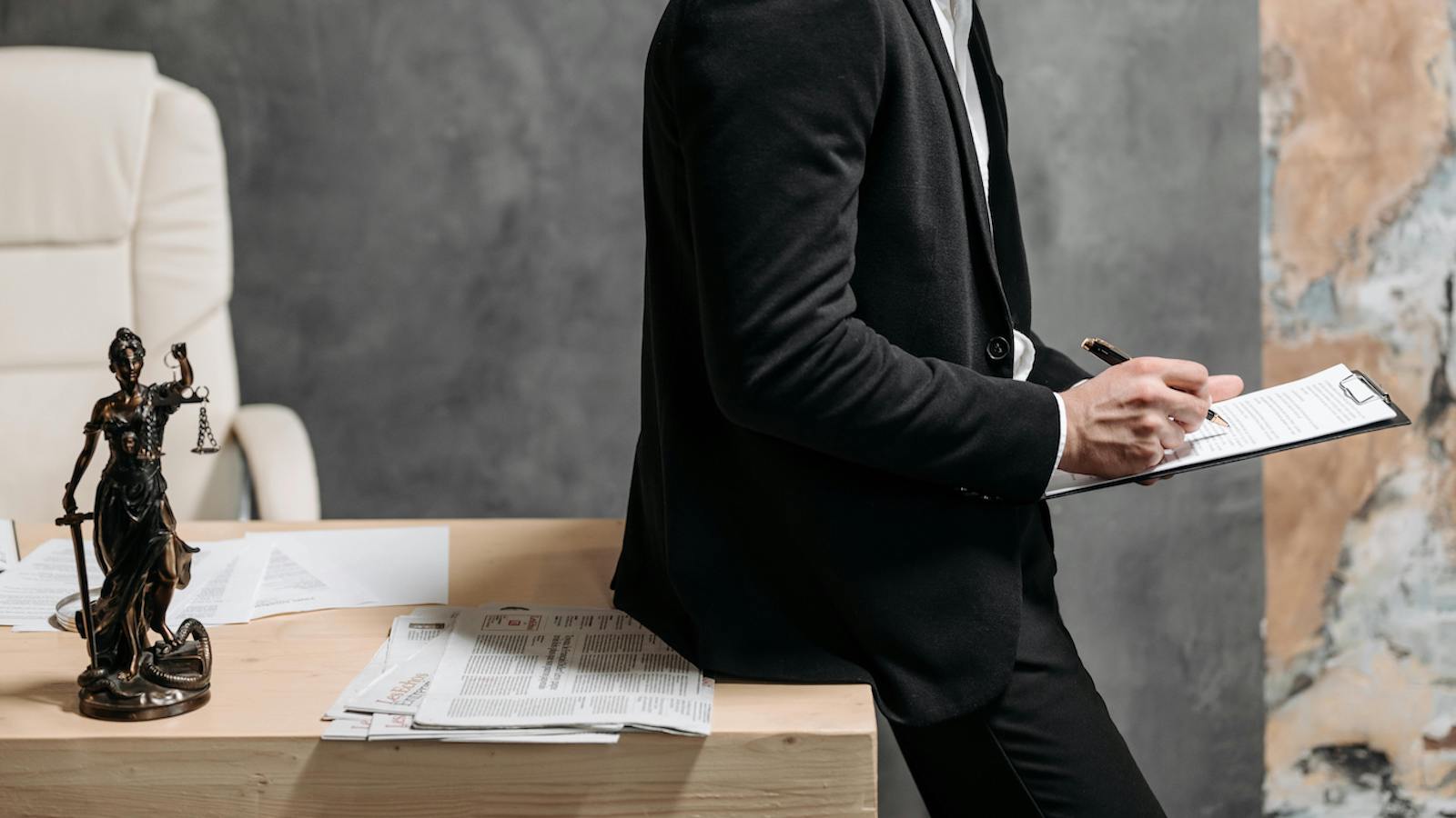 A Man in Black Suit Reading a Contract