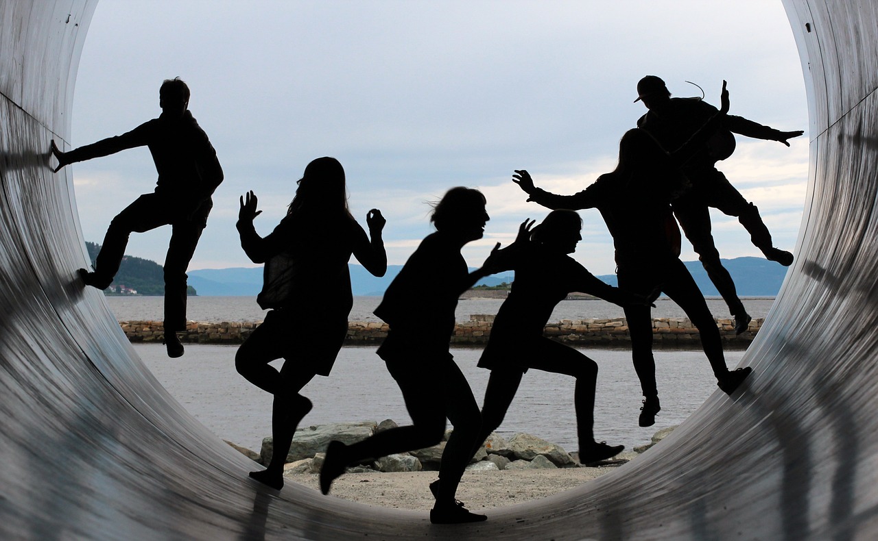 people jumping inside a cylinder