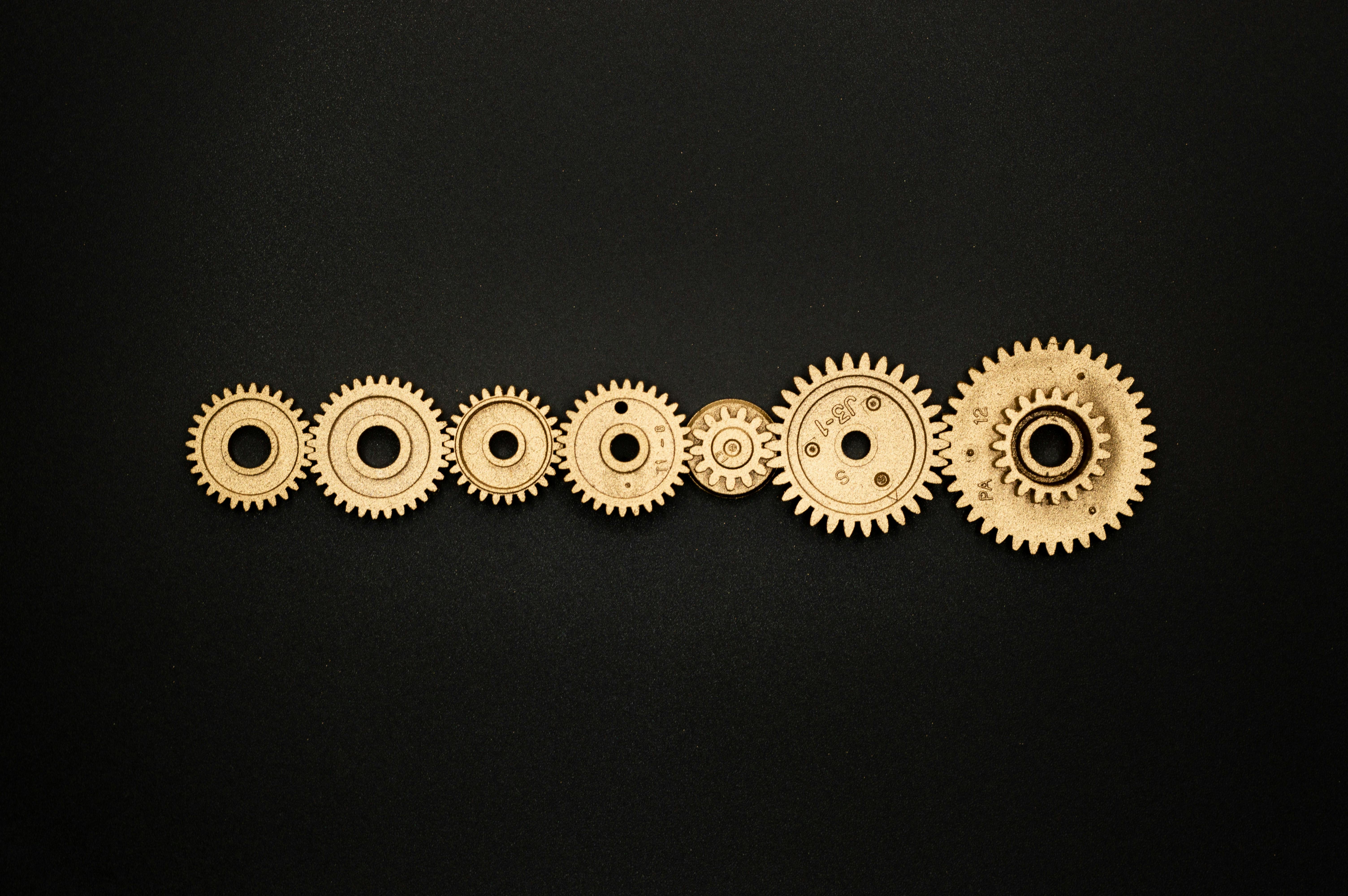 Photo of Golden Cogwheel on Black Background