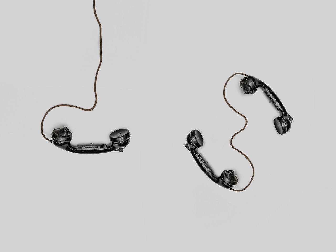 three black phone handsets