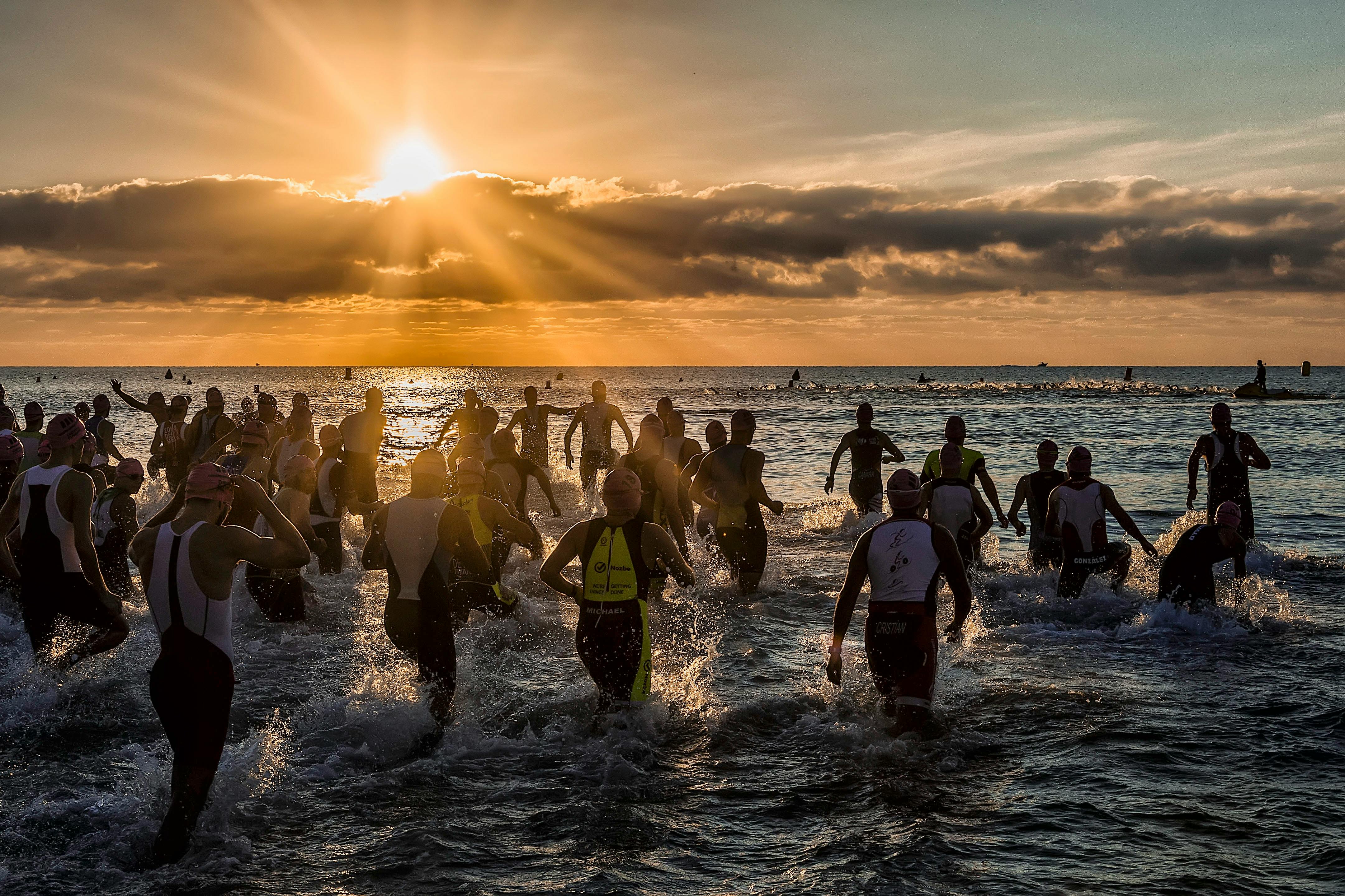 People Bathing in the Sea at Sunrise