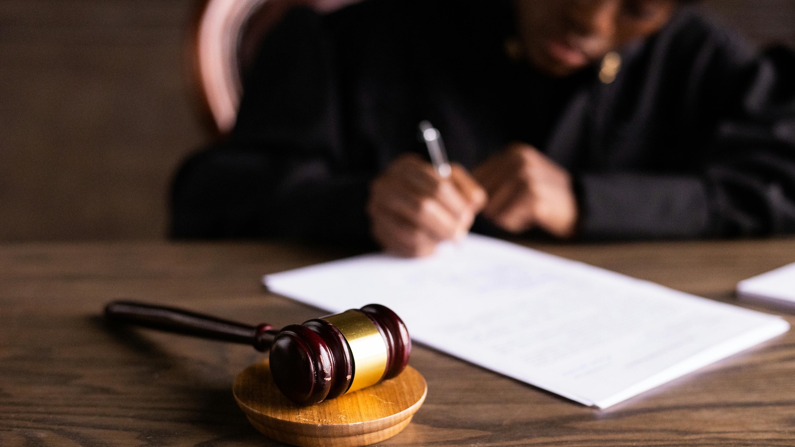 Gavel in front of judge signing papers