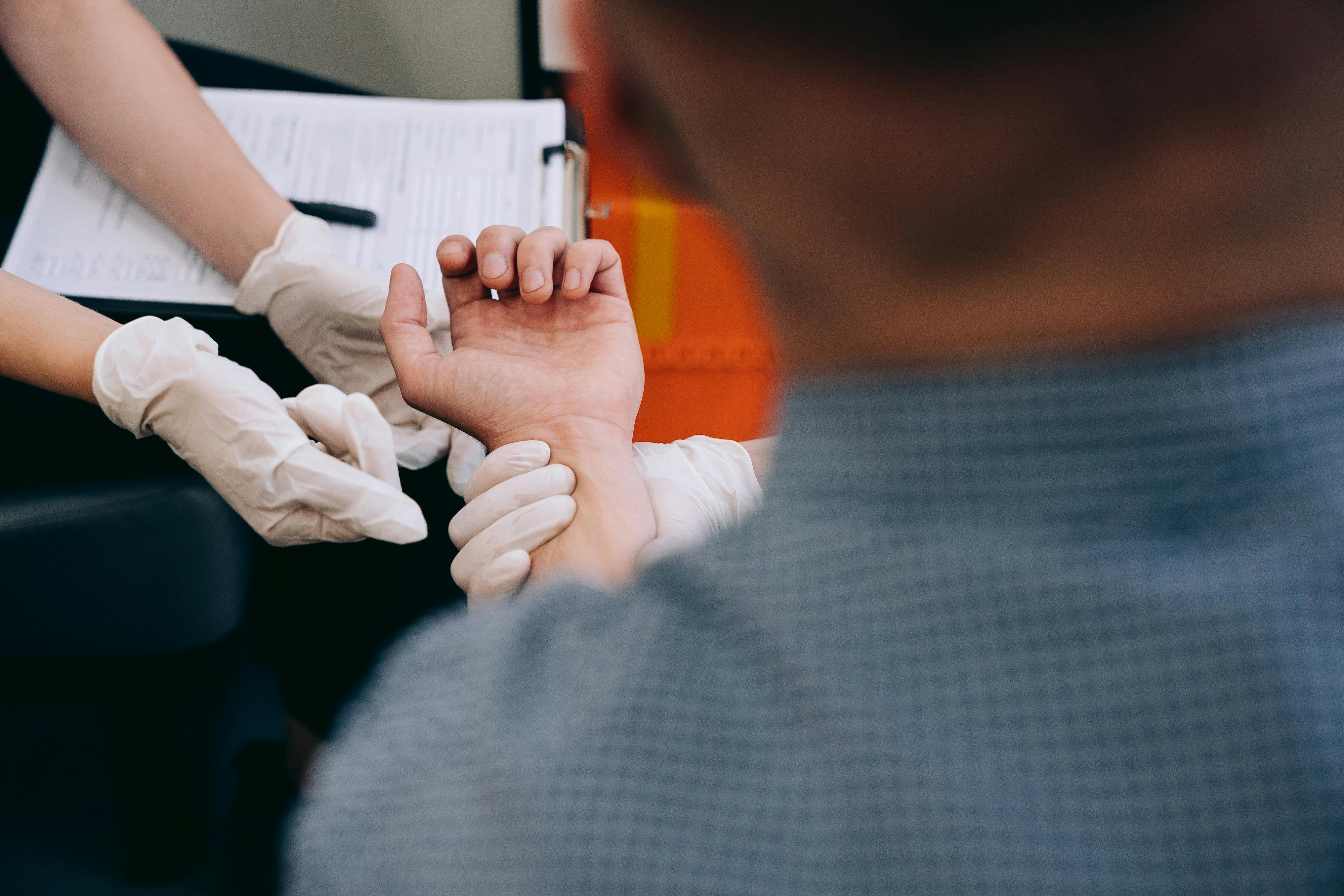 Close-up of Paramedics Holding Hand of a Patient