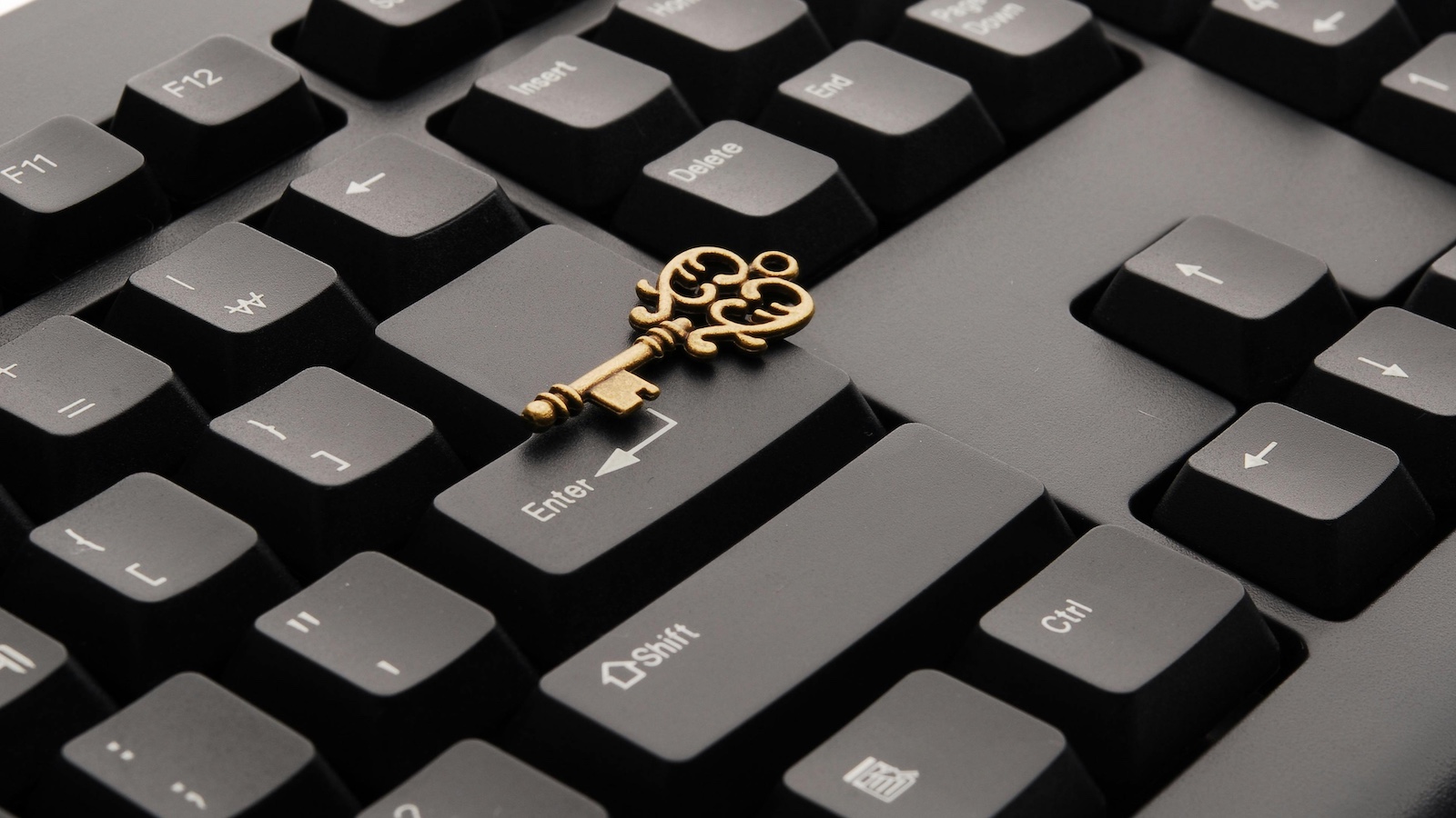 Brass Ornate Vintage Key on Black Computer Keyboard