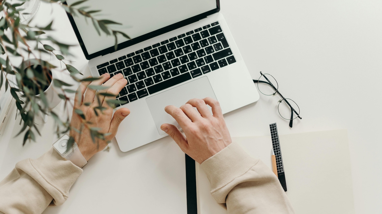 Person in Beige Long Sleeve Shirt Using Laptop