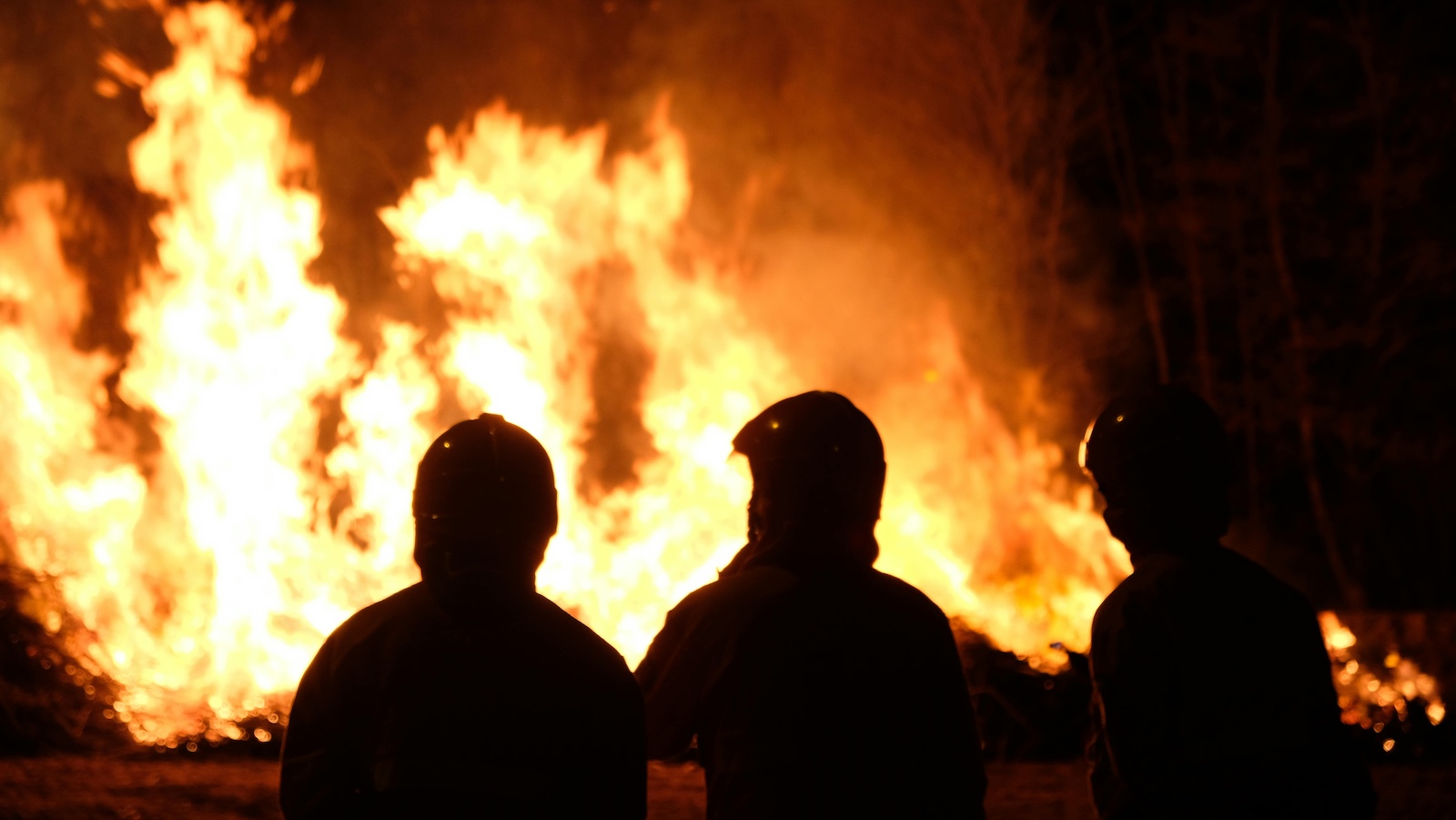 Silhouette of Firefighters Near the Blazing Fire