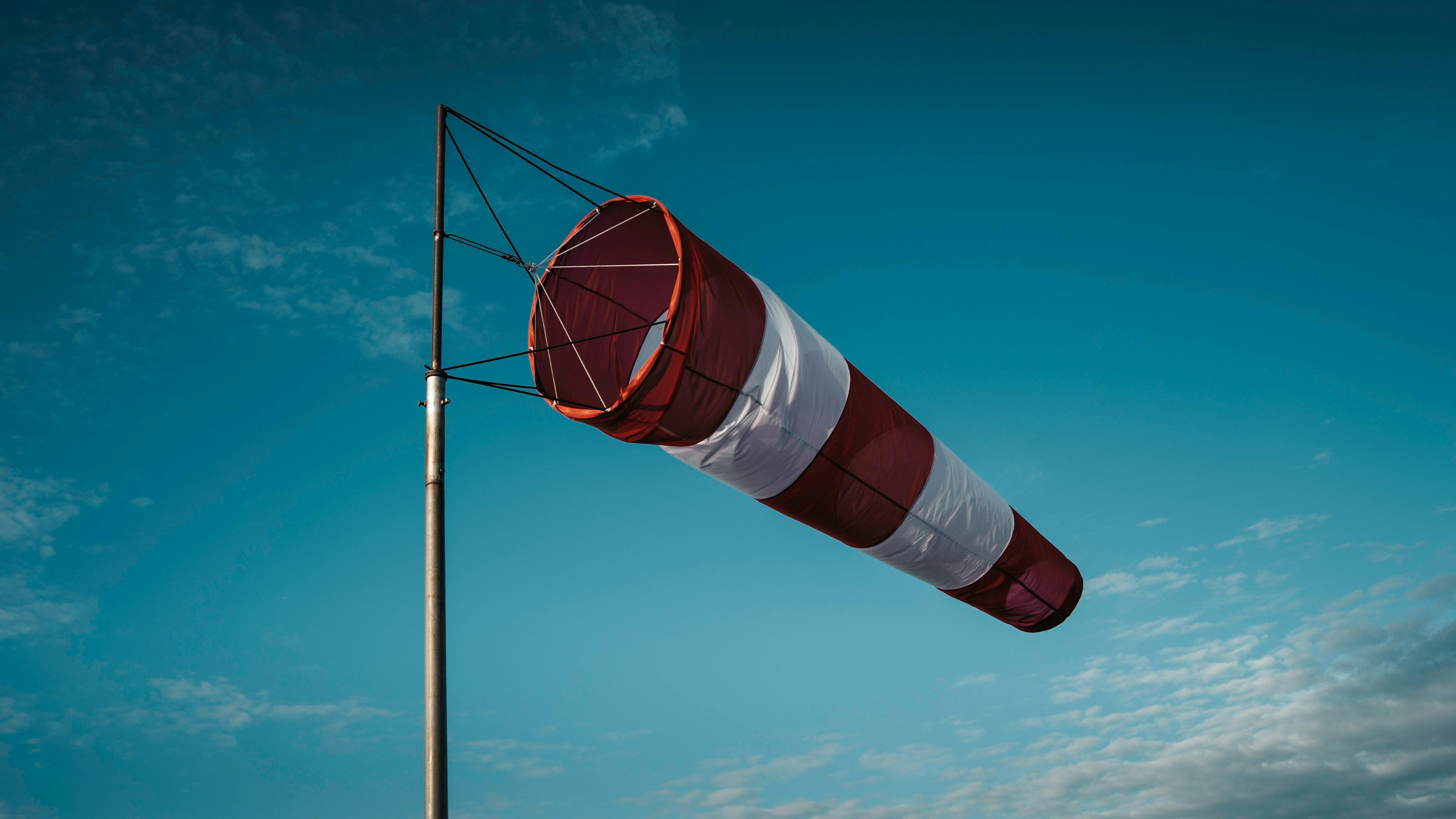 Red and White Windsock Against Clear Sky