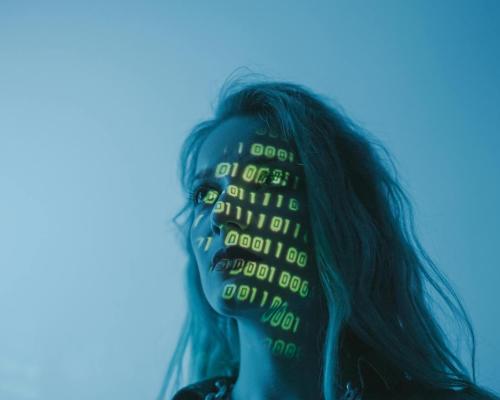 A woman looking afar with binary projected on her face