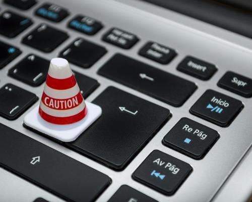 caution cone on computer keyboard