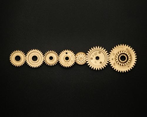 Photo of Golden Cogwheel on Black Background